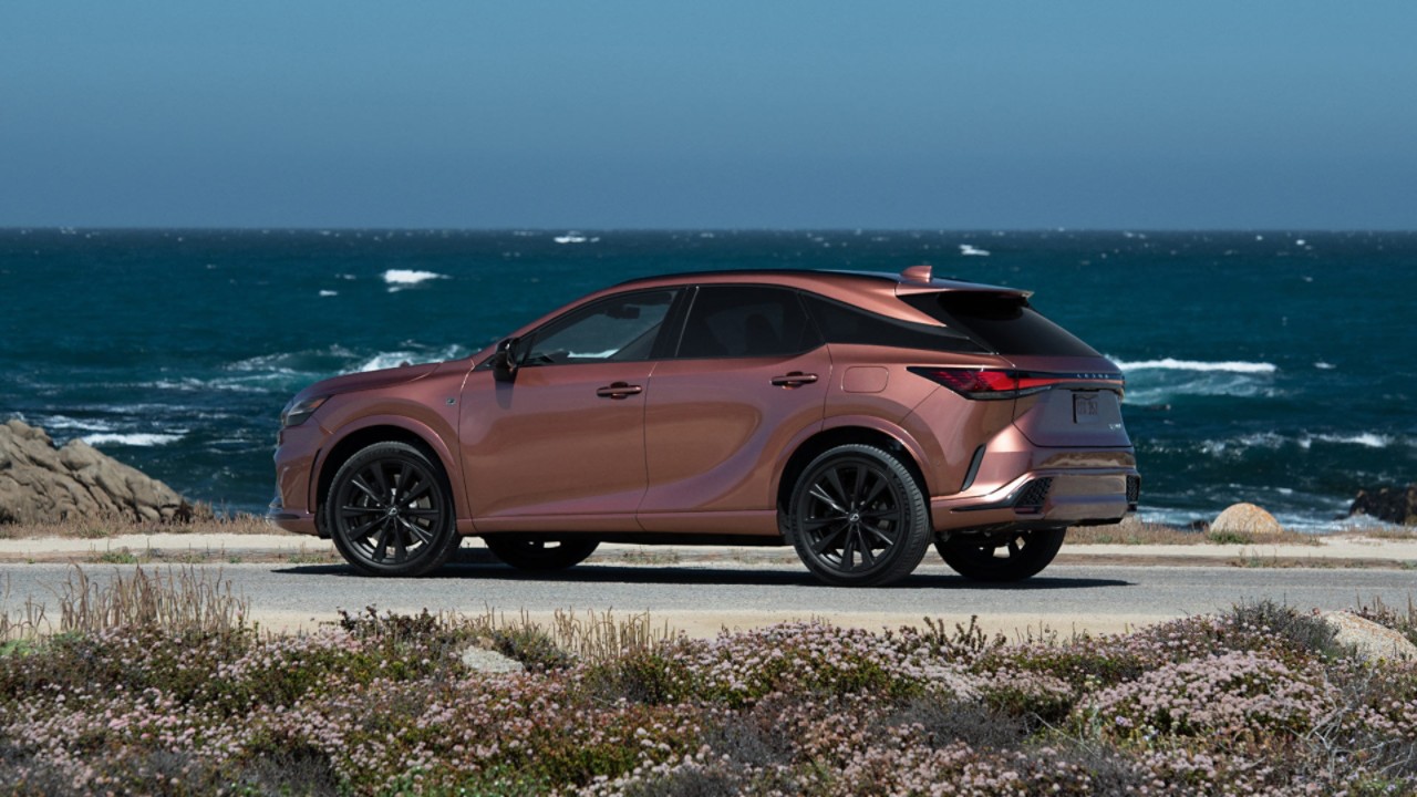 A Lexus RX 450h+ parked in a garage opening