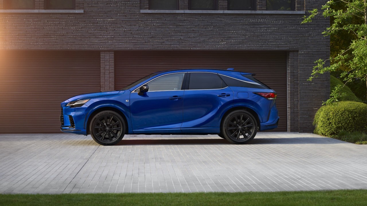 Rear view of a Lexus RX 450h+ parked outside a building