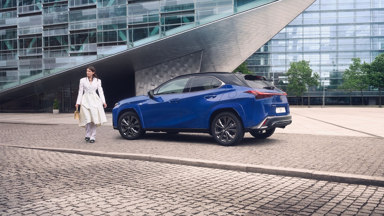 A person walking away from a Lexus UX