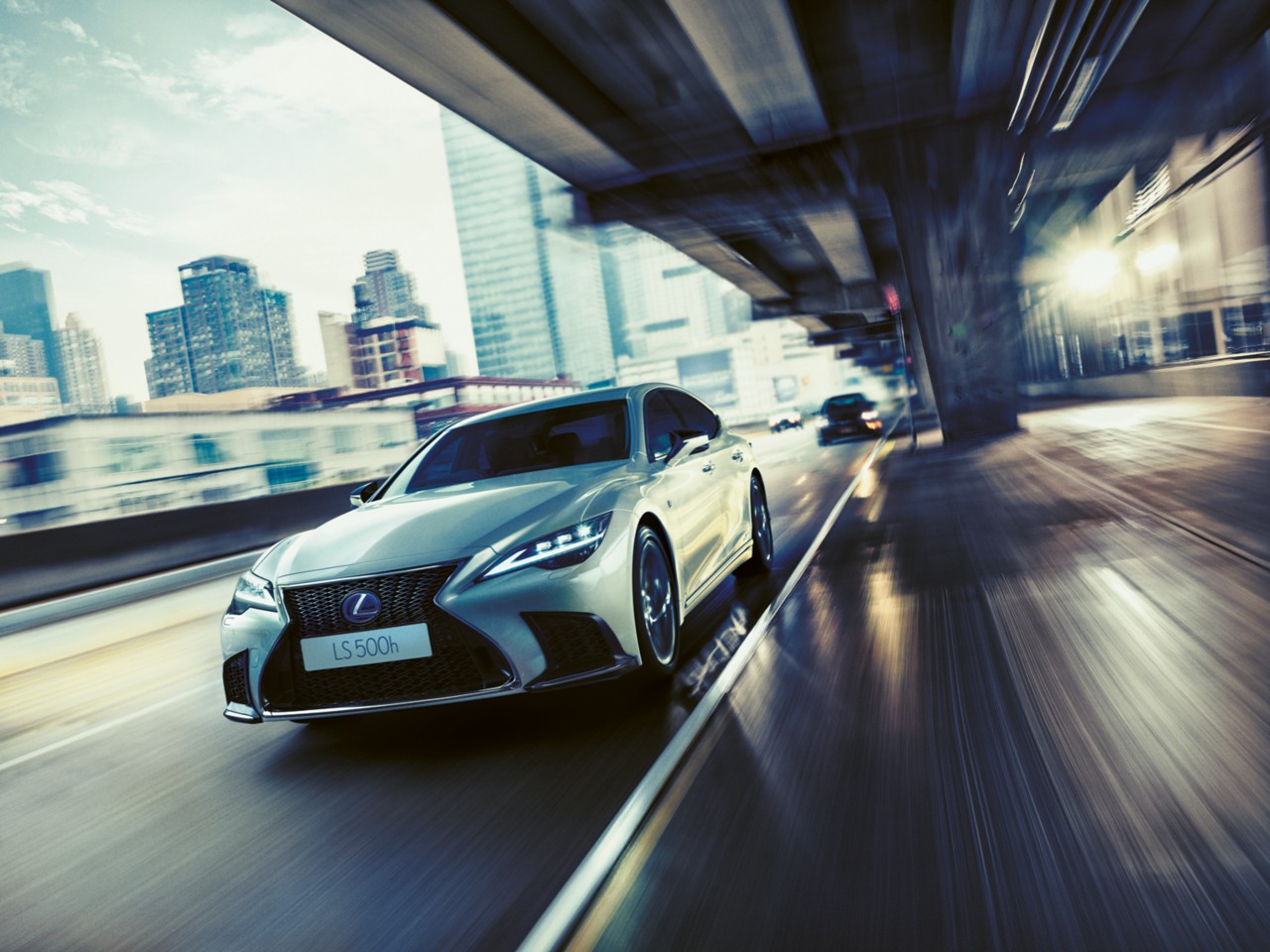 Lexus LS 500h driving in a city location 